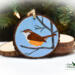 A Carolina wren hand-painted on a wood slice Christmas ornament available for purchase at Cove Creek Photography.